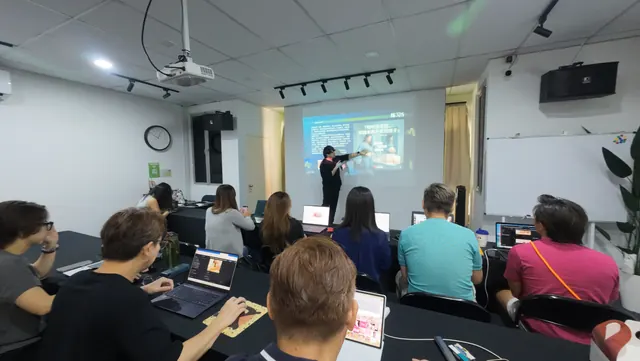 Participants following along on laptops during a live training session