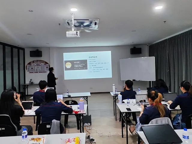 Wide view of a classroom session with participants at their laptops