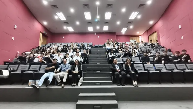 A full lecture hall of participants at a training session